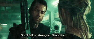 A Man Is Holding A Gun And A Woman Is Holding An Apple . GIF