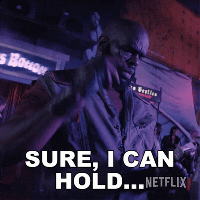 A Man Is Holding A Gun And Says " Sure I Can Hold " GIF