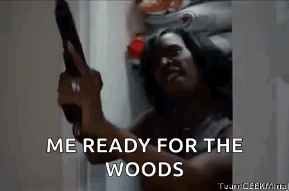 A Man Is Holding A Gun In A Refrigerator And Saying `` Me Ready For The Woods '' . GIF