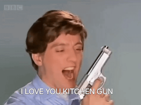 A Man Is Holding A Gun In His Hand And Screaming . GIF