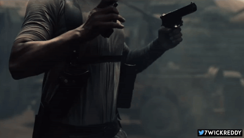 A Man Is Holding A Gun With The Twitter Username 7Wickreddy Visible GIF