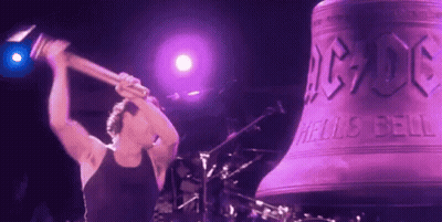 A Man Is Holding A Hammer In Front Of A Large Bell That Says Ac Dc On It GIF