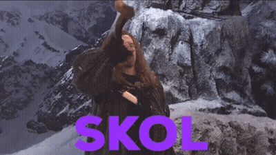 A Man Is Holding A Hammer In Front Of A Mountain And The Word Skol Is In Purple GIF