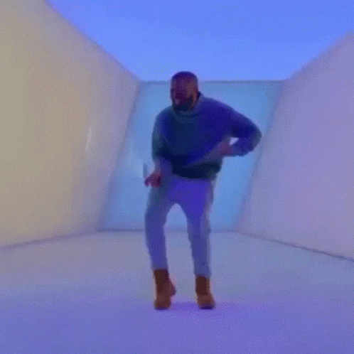 A Man Is Holding A Heart Shaped Tennis Racket In A Room GIF