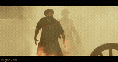 A Man Is Holding A Large Shield Over His Head In A Scene From A Movie GIF
