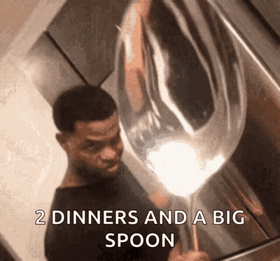 A Man Is Holding A Large Spoon That Says " 2 Diners And A Big Spoon " GIF