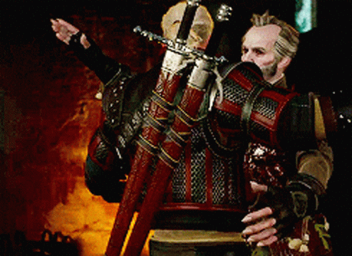 A Man Is Holding A Large Sword In His Hands GIF