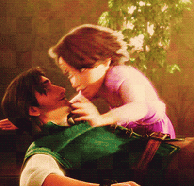 A Man Is Holding A Little Girl In His Arms GIF