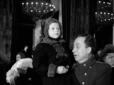 A Man Is Holding A Little Girl In His Arms GIF