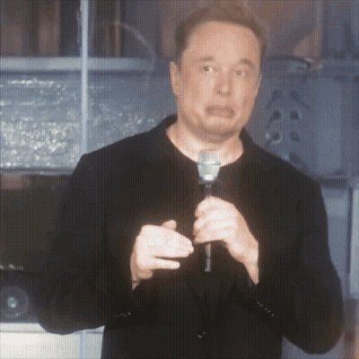 A Man Is Holding A Microphone And Making A Face GIF