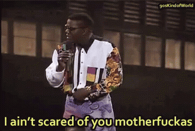 A Man Is Holding A Microphone And Says I Ain 'T Scared Of You Motherfuckas GIF