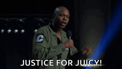 a man is holding a microphone and says justice for juicy .