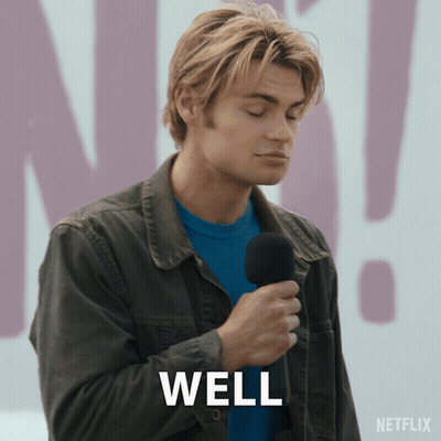 A Man Is Holding A Microphone And The Word Well Is On The Screen GIF