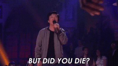 A Man Is Holding A Microphone In Front Of A Crowd And Says `` But Did You Die ? '' GIF