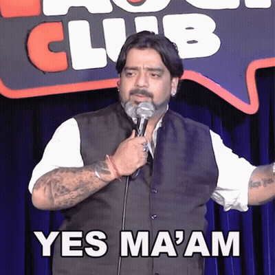 A Man Is Holding A Microphone In Front Of A Sign That Says Club GIF
