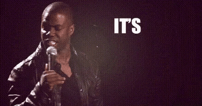 A Man Is Holding A Microphone In Front Of A Sign That Says `` It 'S About To Go '' GIF