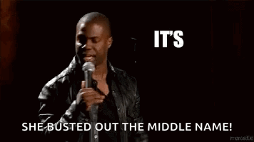 A Man Is Holding A Microphone In Front Of A Sign That Says It 'S About To Go Down She Busted Out The Middle Name GIF