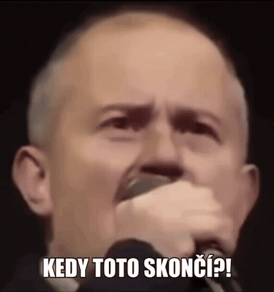 A Man Is Holding A Microphone In His Hand And Making A Funny Face While Singing Into It . GIF