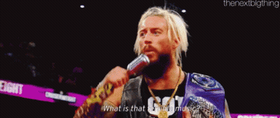 A Man Is Holding A Microphone In His Mouth . GIF