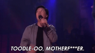 A Man Is Holding A Microphone On A Stage And Saying , `` Toodle-Oo , Motherf *** Er . '' GIF