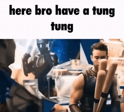 A Man Is Holding A Pair Of Baseball Bats And Talking To Another Man In A Room . GIF