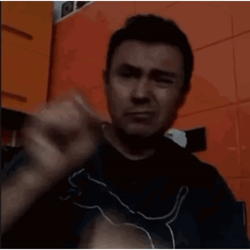 A Man Is Holding A Piece Of Meat In His Hands GIF