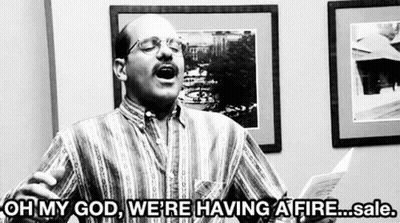 A Man Is Holding A Piece Of Paper And Saying Oh My God We 'Re Having A Fire Sale .. GIF