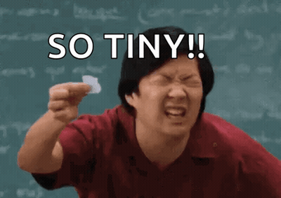 A Man Is Holding A Piece Of Paper In Front Of A Blackboard With The Words So Tiny Written On It . GIF