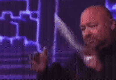 A Man Is Holding A Piece Of Paper That Says Liberal On It GIF