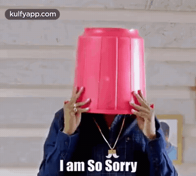 A Man Is Holding A Pink Bucket On His Head . GIF