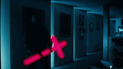 A Man Is Holding A Pink X Shaped Object GIF