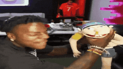 a man is holding a puppet with a number 7 on it