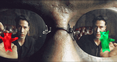 A Man Is Holding A Red Gummy Bear And A Green Gummy Bear In Front Of His Face GIF