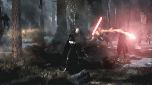 A Man Is Holding A Red Light Saber In A Forest GIF