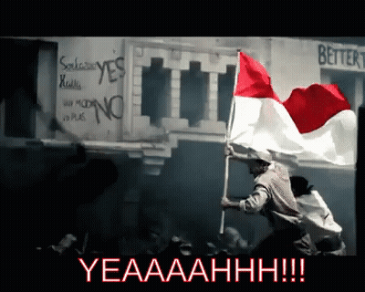 A Man Is Holding A Red White And Blue Flag In Front Of A Sign That Says Better GIF