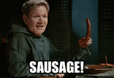 A Man Is Holding A Sausage With The Word Sausage Behind Him GIF