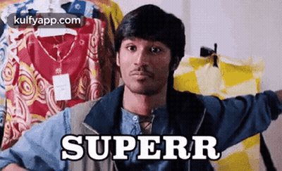 A Man Is Holding A Shirt In Front Of A Row Of Clothes And The Word Superr Is On The Shirt . GIF