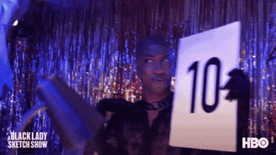 A Man Is Holding A Sign That Says 10 On It GIF