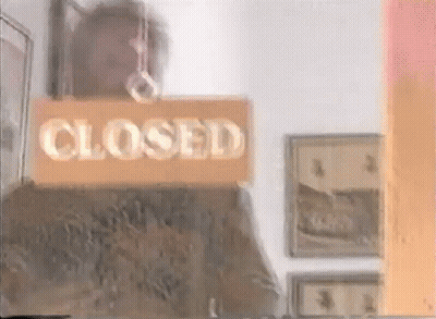 A Man Is Holding A Sign That Says Closed GIF