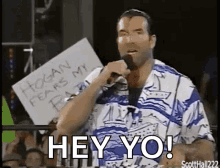 A Man Is Holding A Sign That Says Hogan Fears My Baby GIF