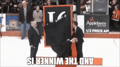 A Man Is Holding A Sign That Says T.g. On It GIF