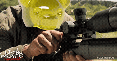 A Man Is Holding A Sniper Rifle And Wearing A Yellow Gummy Bear Mask GIF