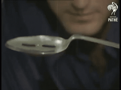 A Man Is Holding A Spoon In Front Of His Face And The Words Focus Are Visible GIF