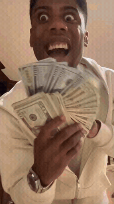 A Man Is Holding A Stack Of 100 Dollar Bills In His Hands GIF