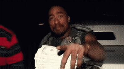 A Man Is Holding A Stack Of Money In His Hand While Sitting In A Car . GIF