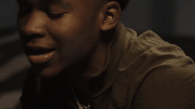 A Man Is Holding A Stack Of Money In His Hands GIF