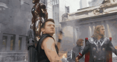 A Man Is Holding A Statue Of Iron Man On His Back And Thor Is Standing Next To Him . GIF