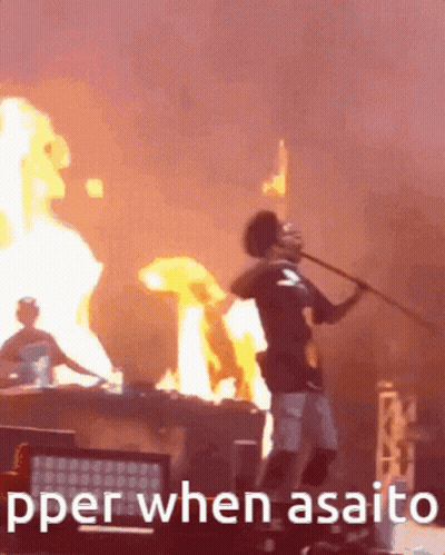 A Man Is Holding A Stick In Front Of A Fire With The Words " Pper When Asaito " Written Below Him GIF