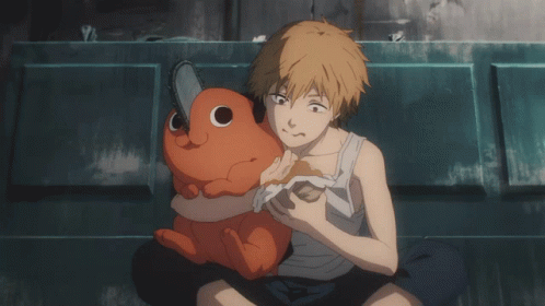 A Man Is Holding A Stuffed Animal With A Chainsaw On It GIF