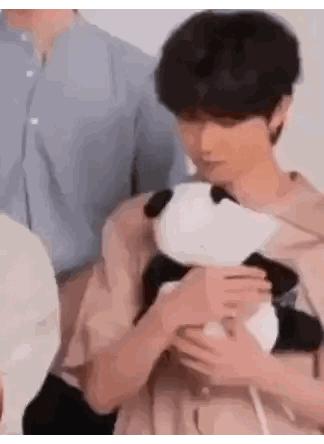 A Man Is Holding A Stuffed Panda In His Arms . Sticker